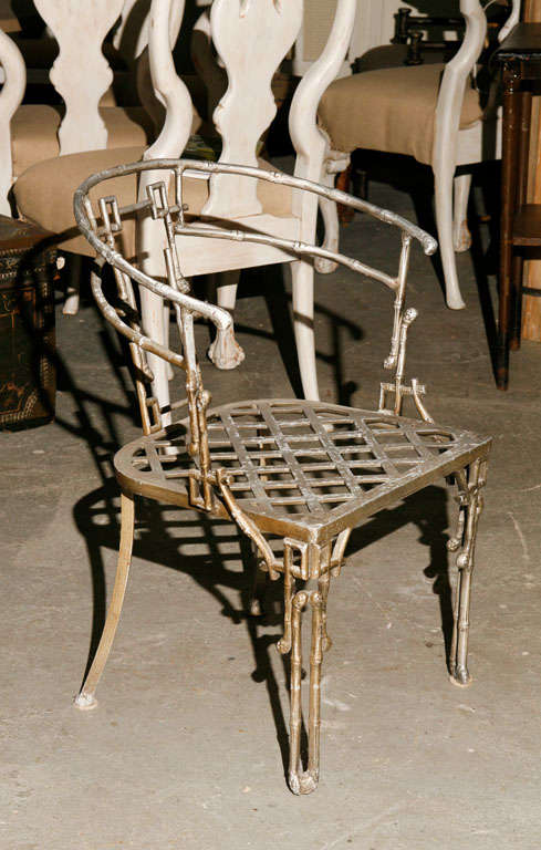 Very stylish faux bamboo metal barrel back metal arm chair.