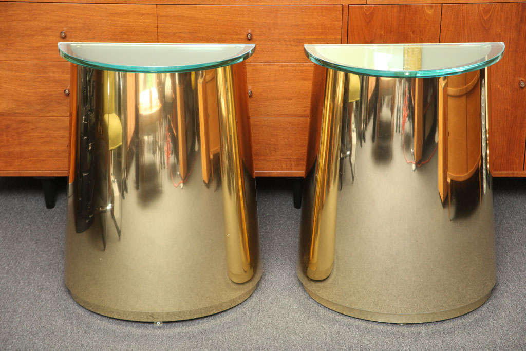 SOLD NOV 2012 Sleek, sophisticated and modern...this pair of half moon shaped console tables, clad all around in very reflective brass laminate strike a strong pose with sloped shapes,  their bottoms slghtly larger than the tops...the 3/4