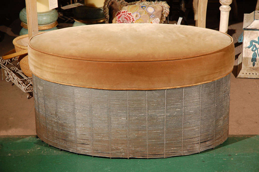 This piece is most unusual--it is an oval ottoman with a spun wire bottom and an upholstered top. The velvet on it is wrong, but this piece is so different, and could go in many different decors with the proper fabric. Never seen one like it!