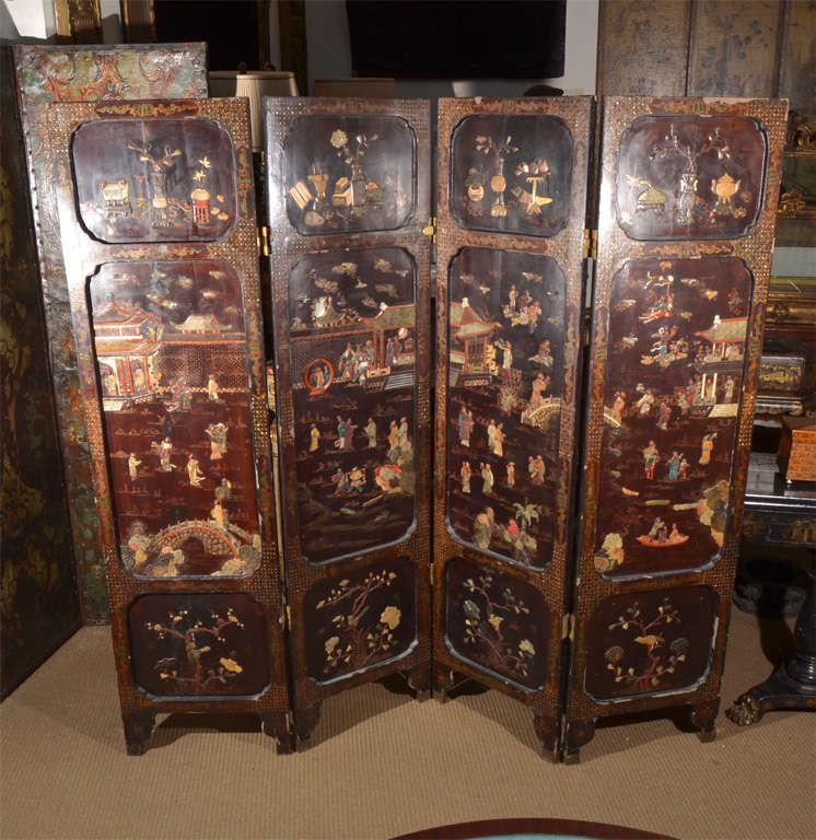 a four panel screen with embellishments, both painted and applied carved stone flowers on the bottom panels, people doing various tasks in the center panels and vases of flowers. Mother of pearl inlay around the frame. Each panel measures 19