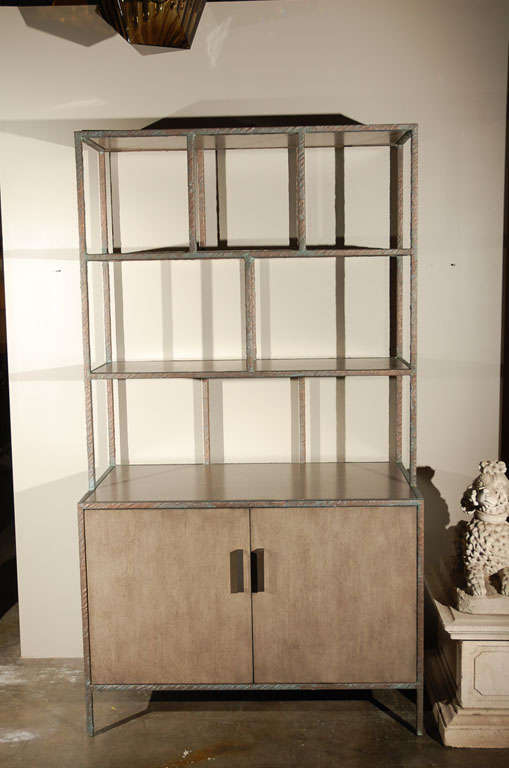 Modern Paul Marra bookcase shown in metal frame wrapped with embossed faux bronze, inset shelves and doors shown in gray wash. By order. Can be custom-ordered.