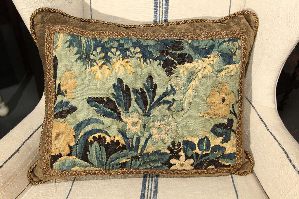 blue, black, teal and stone hued tapestry  trimmed with braiding and backed in stone velvet.  down insert