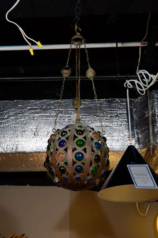 Vintage Moroccan jeweled metal ball light fixture.  Morocco, circa 1960.<br />
<br />
Metal ball-shaped fixture with pirced design and multi-color jewel, suspended fromthree metal wires.