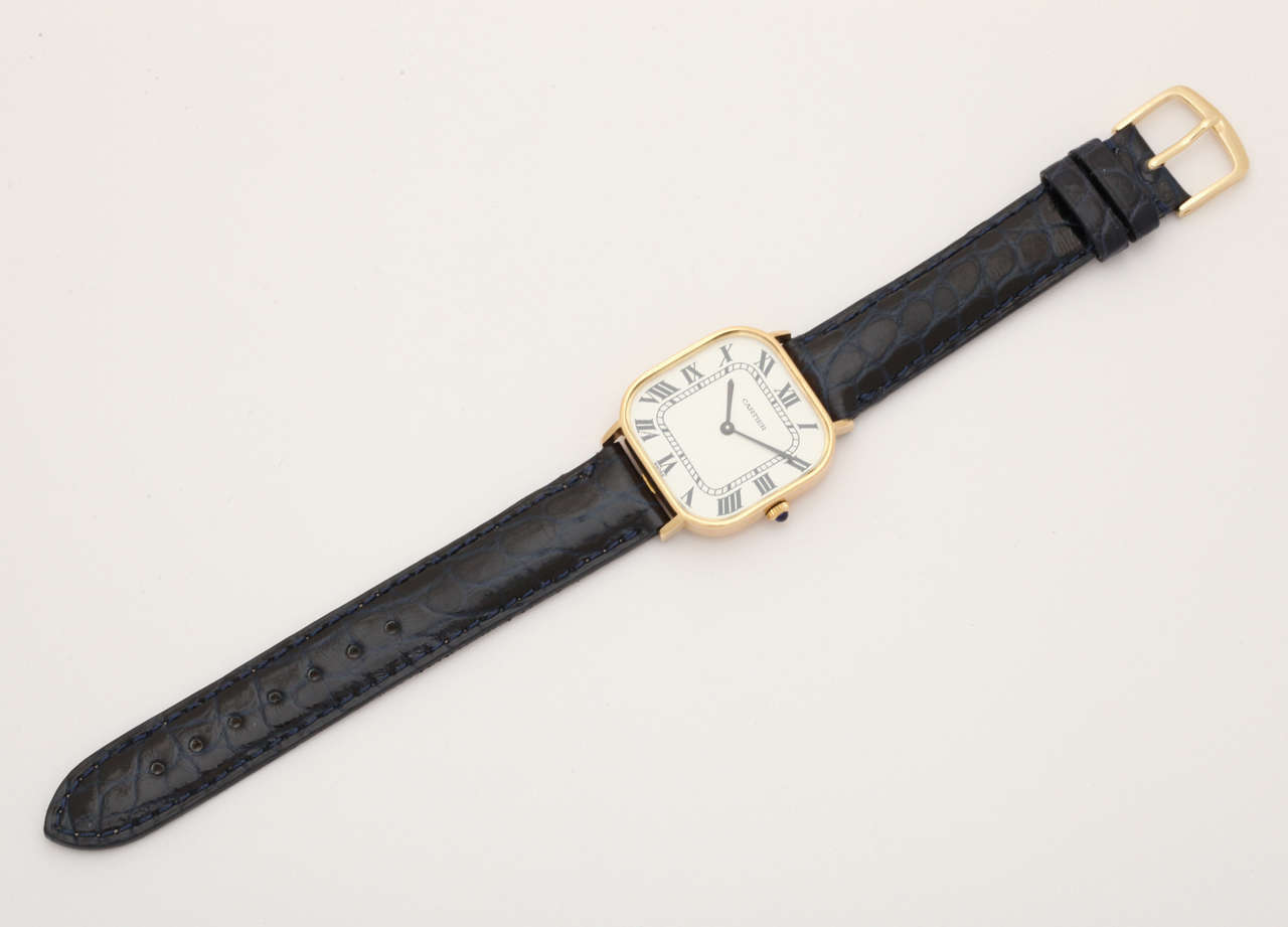 A beautiful, and quite unusual large size 18k yellow gold mechanical wrist watch by Cartier.  The watch is everything that has come to be expected from this iconic luxury company;  Wonderful quality case. The classic, clean Roman numeral dial.  The
