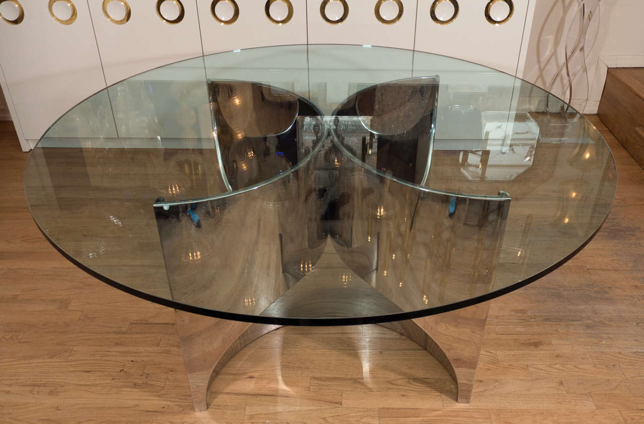 Undulating stainless steel dining table with circular glass top attributed to Brueton.
