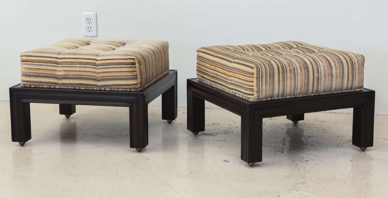 Pair of Mid-Century Ottomans with original upholstery.  The legs have casters.