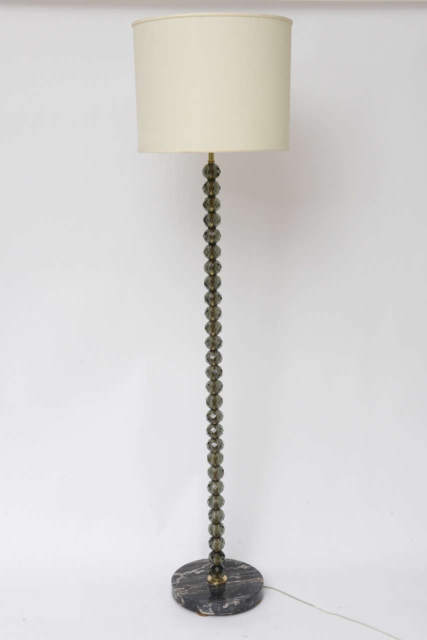 A towering stack of smoke grey faceted crystal balls makes for a glittering, glamorous midcentury Italian floor lamp, with black marble base and brass hardware. (Shade not included.) Height measurement below is to top of socket.