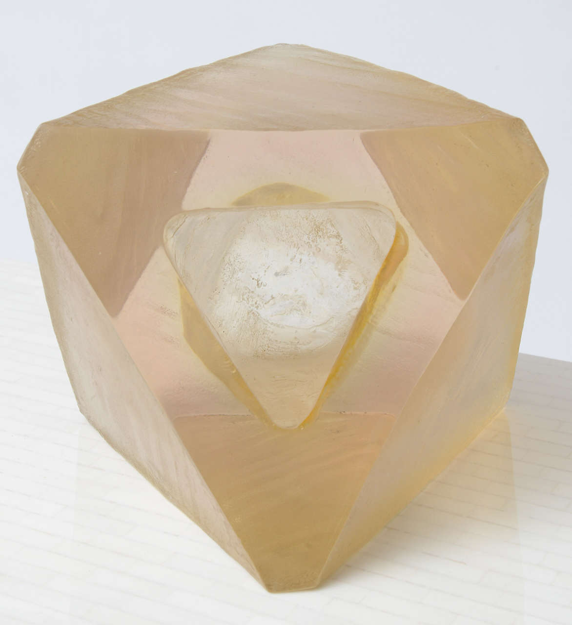 Unsigned 70's polyhedral sculpture. Rough textured resin sides, polished front with hollowed out triangular form. Original owner's heirs could only confirm it being purchased circa 1970.