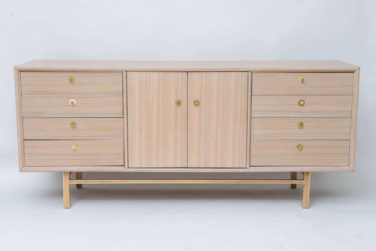 Love the horizontal and vertical graining on this American Mid-Century Modern dresser or credenza! Bleached teak with brushed brass hardware and leg trim. Beach-side beauty!