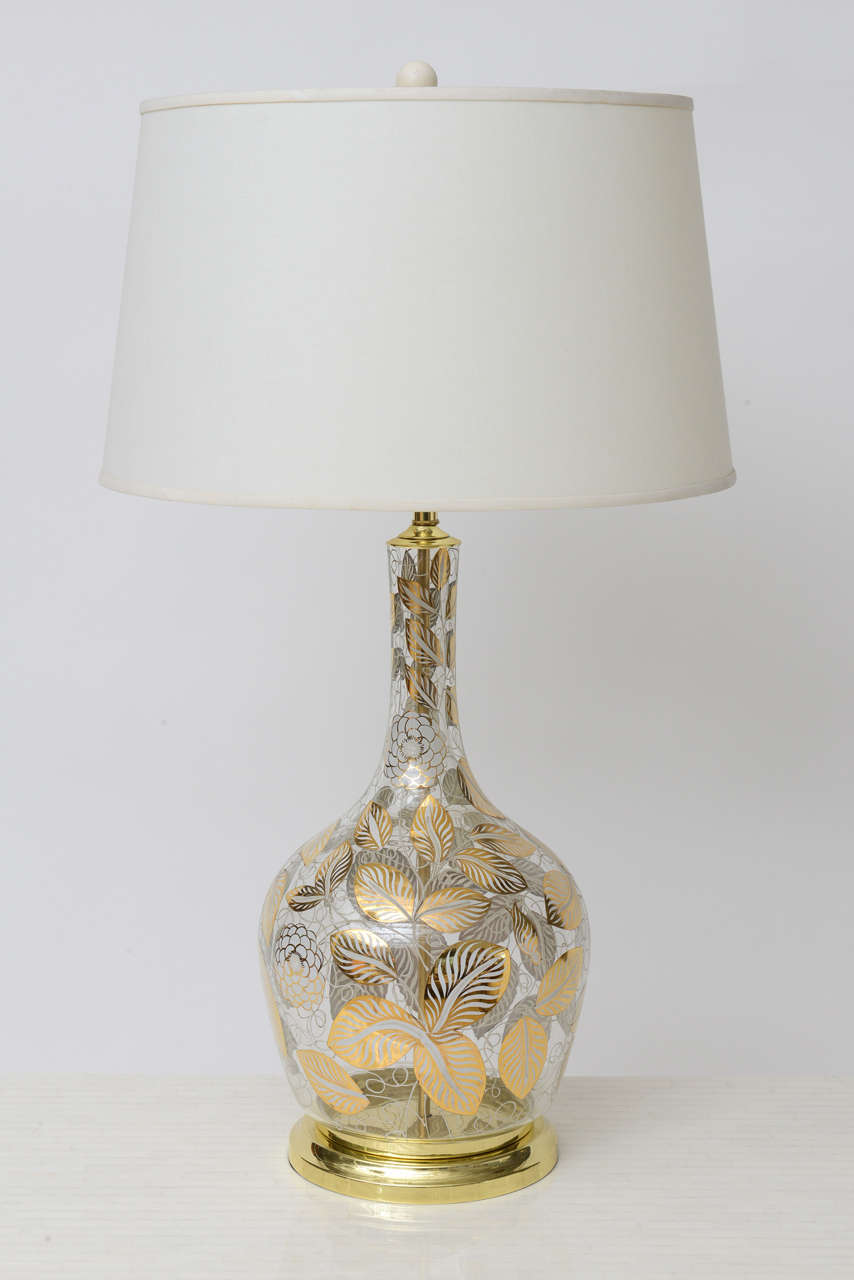 We love the Josef Frank-inspired floral pattern on this gorgeous pair of American Modernist lamps. Hand-painted in gold and white on clear glass. Fully restored and re-wired. Brass bases and hardware.