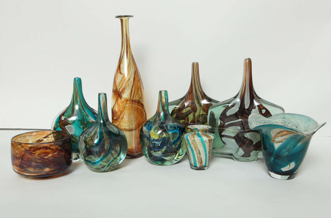 Collection of 1960s and 70s Maltese studio glass, made under the direction of English glass artist Michael Harris at his Mdina workshop.  This assortment has a good range of their brown, tiger eye and sand colors along with the rich blue, aqua,