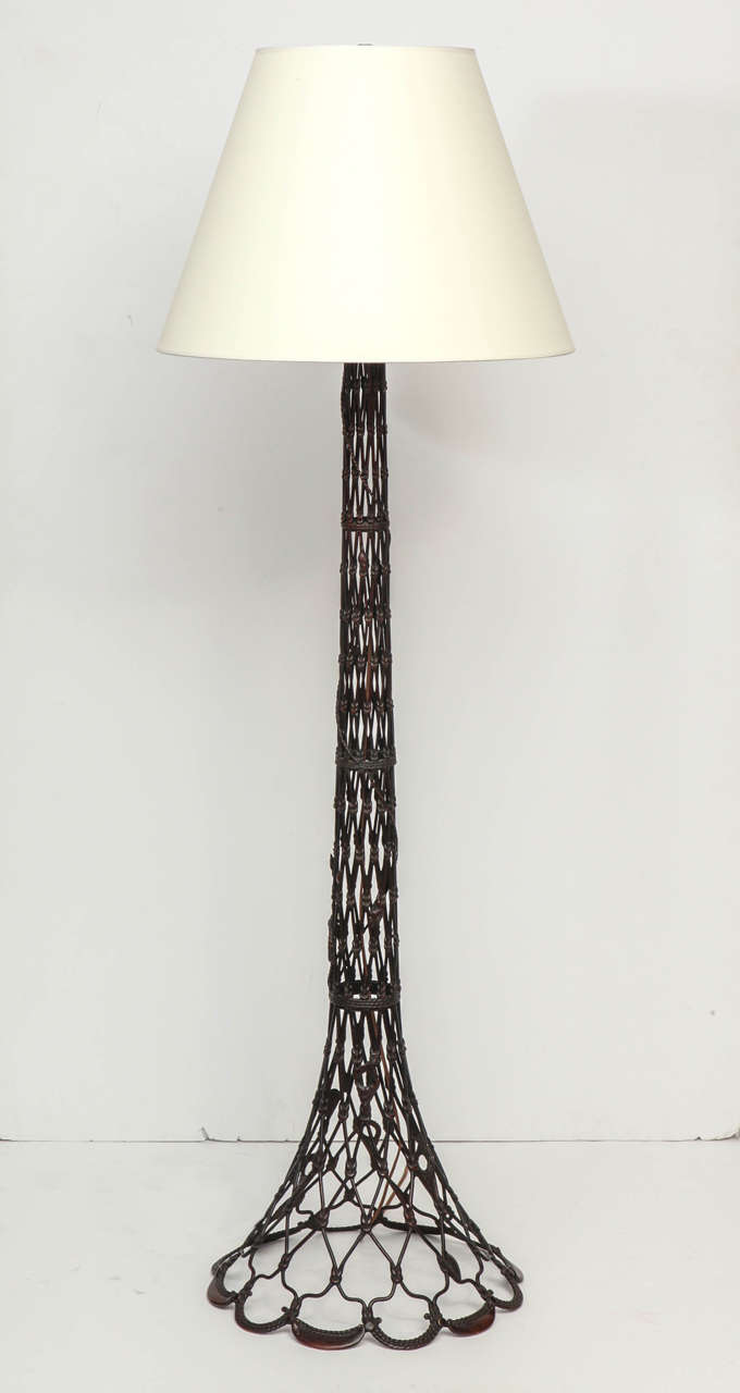 An unusual Danish cast patinated bronze floor lamp, early 20th century. The spreading stem in the form of a fish trap encrusted with small leaves and shells.

Now wired to US spec.