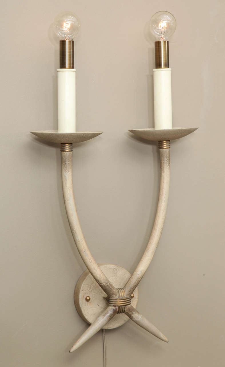 Large horn-shaped double arm wall sconces in a matte textured organic faux finish. Capped with brass socket surrounds. Each sconce uses two E12 candelabra base bulbs up to 60 watts each. Newly rewired and UL listed.