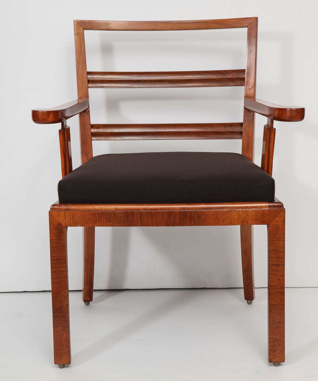 European walnut ladder-backed armchair attributed to Erik Chambert, circa 1940. Classically referenced form with an unusual "linenfold" detail to the arm supports. Newly French polished and reupholstered in natural linen.