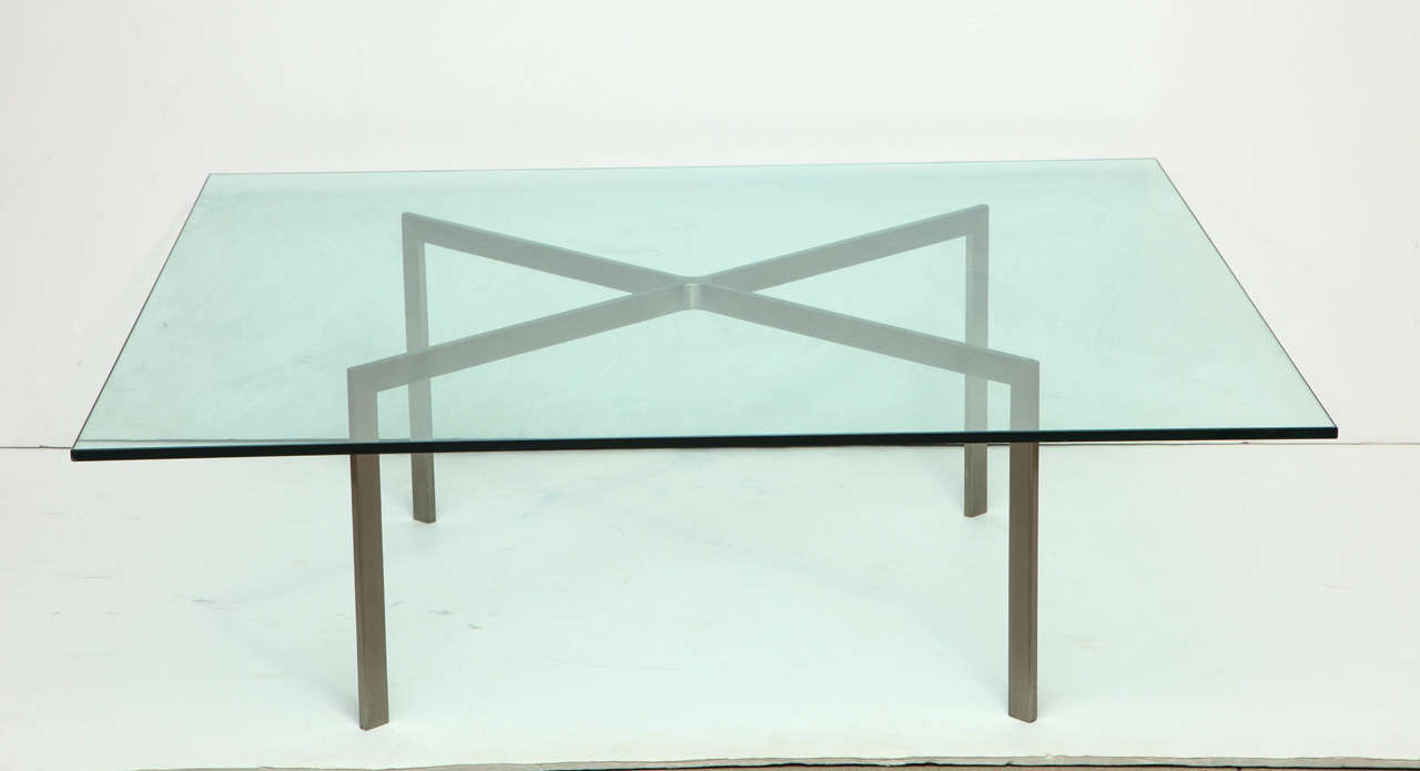 Custom X-frame coffee table with a brushed steel base and glass top by Nicos Zographos. Note the signature Zographos center weld joint for the four pieces of steel.