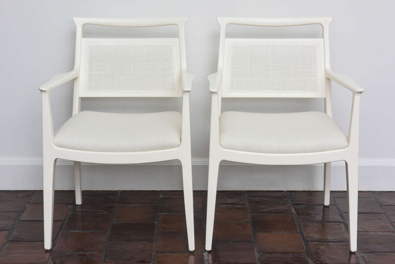 A lovely pair of cane-backed armchairs by legendary designer Paul McCobb. 

Bone-colored lacquered frames against color-matched silk linen truly set this pair apart from the rest. A very pretty pair of McCobb classics.