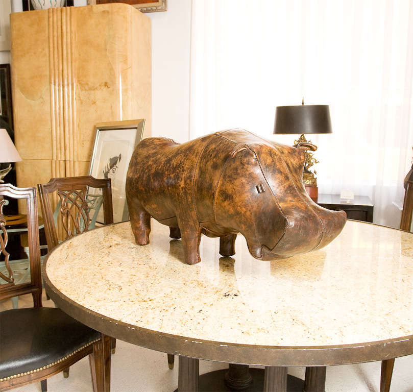 Great hippo in beautifully patinated leather that may be used as a footstool, or can support a seated adult.<br />
Presently nicknamed Hugo, feel free to come by our showroom to visit him in person.<br />
Better yet, adopt Hugo today!