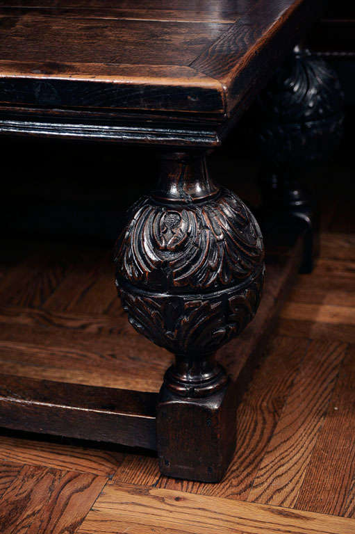 Elizabethan Revival Carved Oak Coffee Table with Richly-Patinated Plank Top, Traditional Acanthus Leaf Design and Stretcher Base. Reduced From Original Height. England, 19th Century.<br />
<br />
48 inches wide x 30 inches deep x 20 inches high