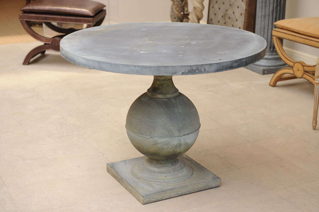Late 20th Century patinated zinc round pedestal table. The exaggerated bulbous form the pedestal on a square plinth.