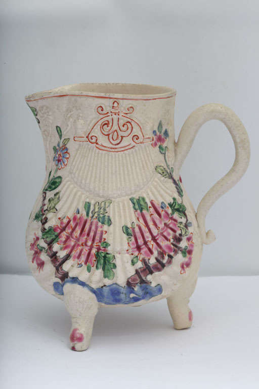 A rare English enameled saltglazed stoneware pectin shell shape creamer on three legs decorated with Oriental flowers