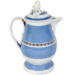 A Light Blue Mocha Covered Milk Jug