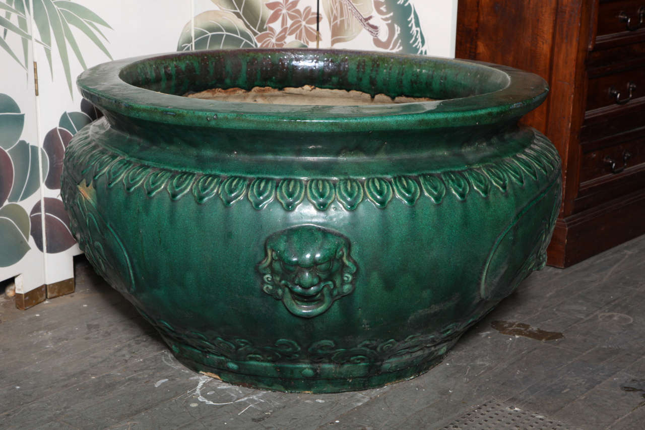 Originally from the Hunan Province, these are some of the largest planters we have ever had in our collection.

Glazed in a rich green over a deeply carved bird and flower design and well defined lion head masks. 

Four pieces available. Price