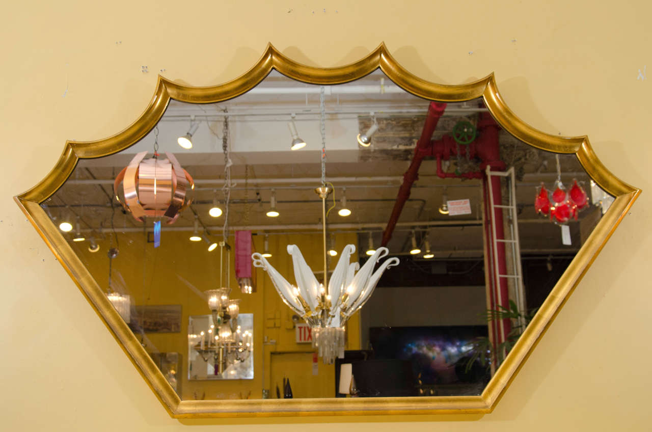 Lovely mirror with a playful form! The finish of the frame is gold leaf. Please contact for location.