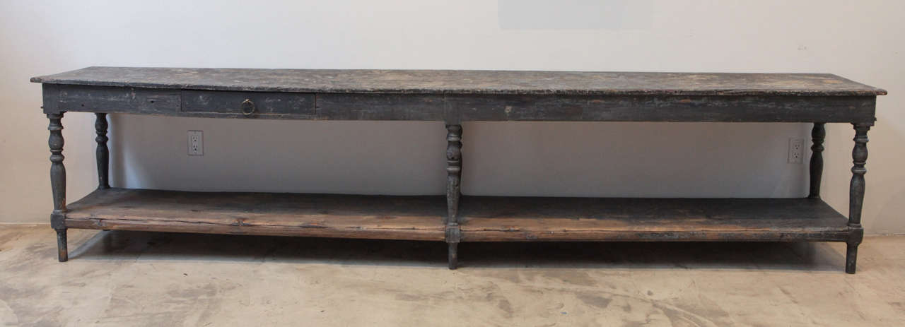 A long double shelf, single drawer console from Sweden. In its beautiful deep gray finish. All original.