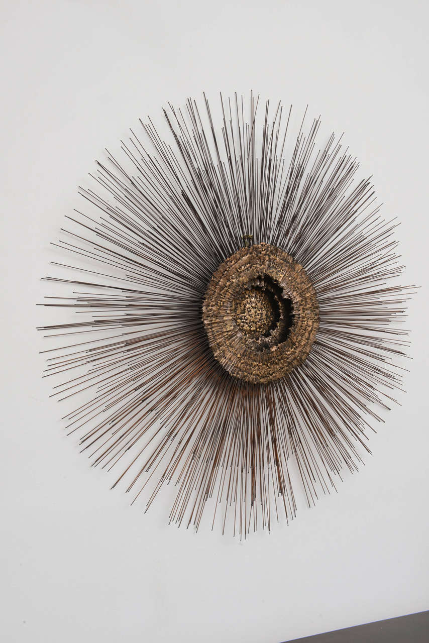 Three layers of copper, brass and dripped bronze sunburst wall sculpture.