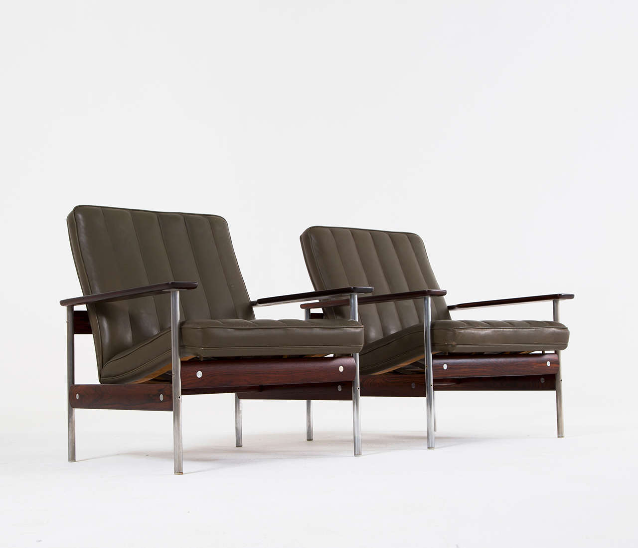 Very sophisticated pair of easy chairs by Sven Ivar Dysthe for Dokke Møbler, Norway, 1959. The base of these lounge chairs is made out of modular rosewood and stainless steel pieces. A clever design makes that the seat seems to float on its