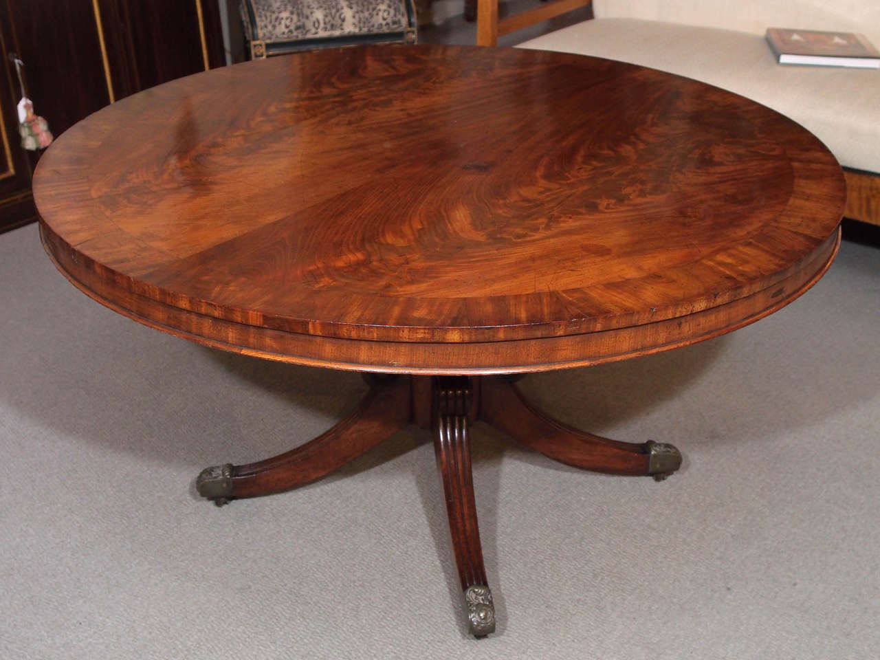 Antique English Regency round mahogany cross banded center table, circa 1810-1820.