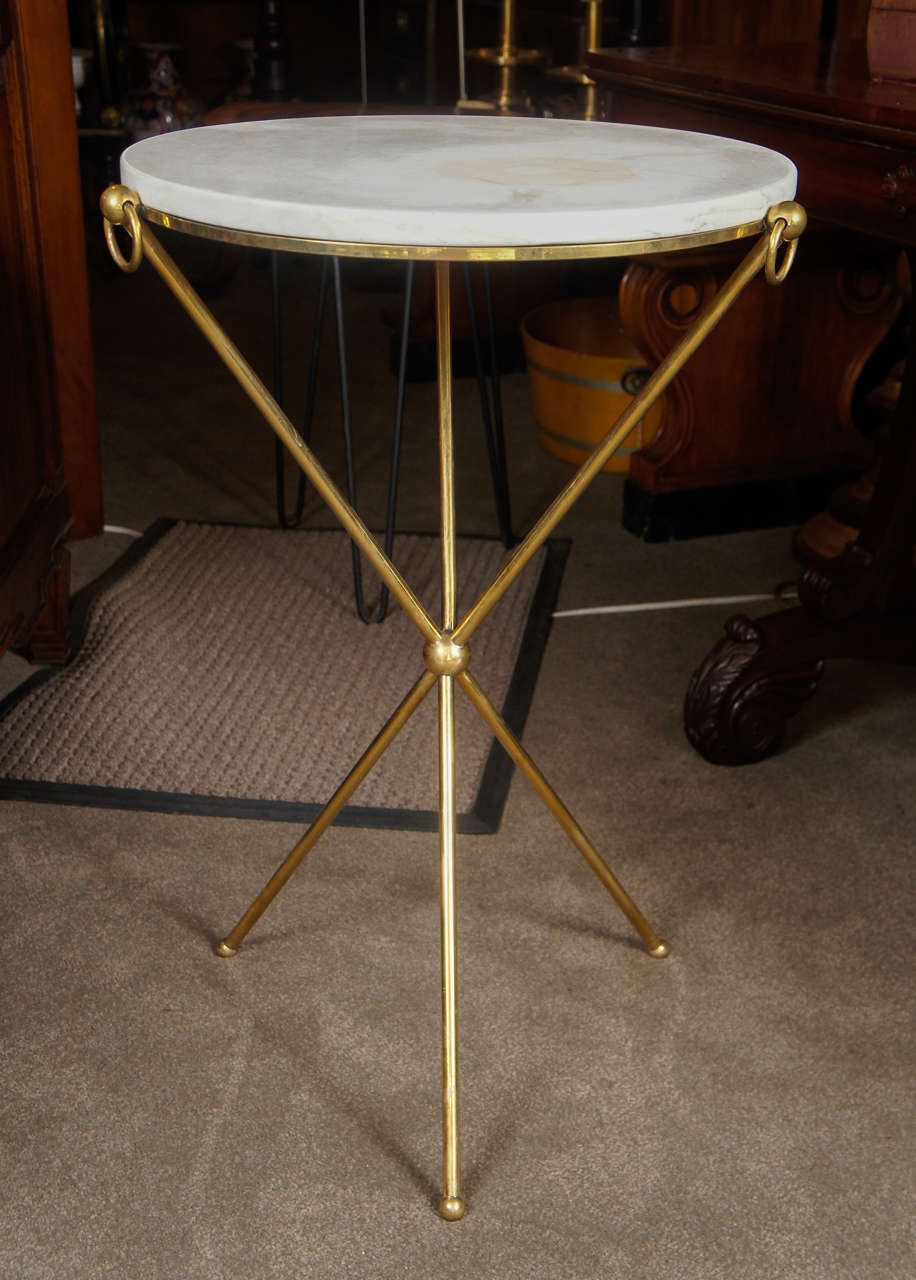 Brass tripod side table with white marble top.