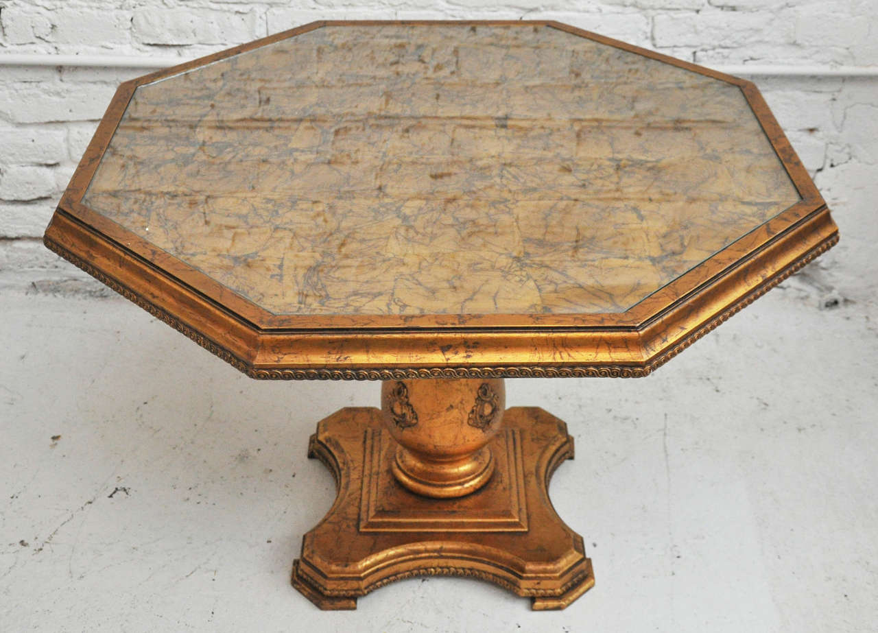 Antique Gold Gilded Octagon Table featuring a beautifully carved pedestal base and glass top.