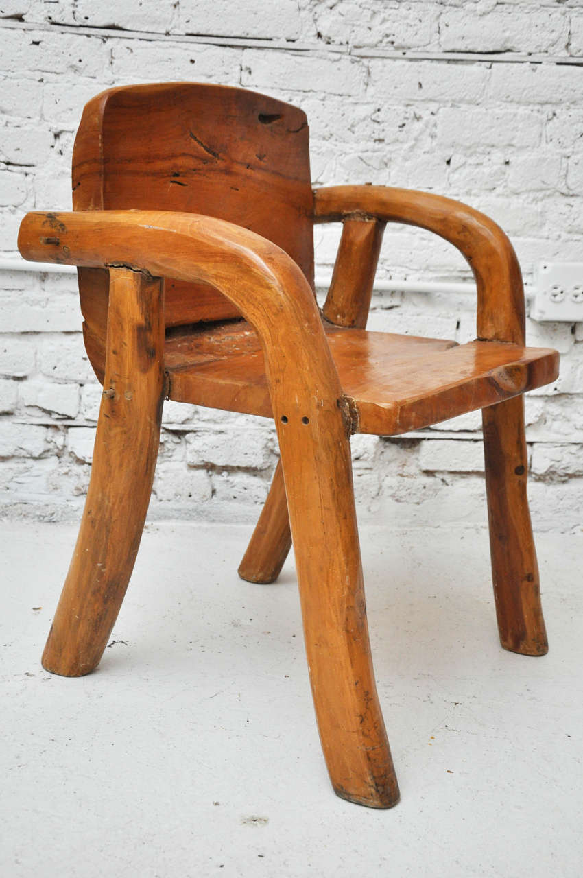 Beautifully hand carved wooden arm chair. A substantial work of art...it's heavier than it looks!