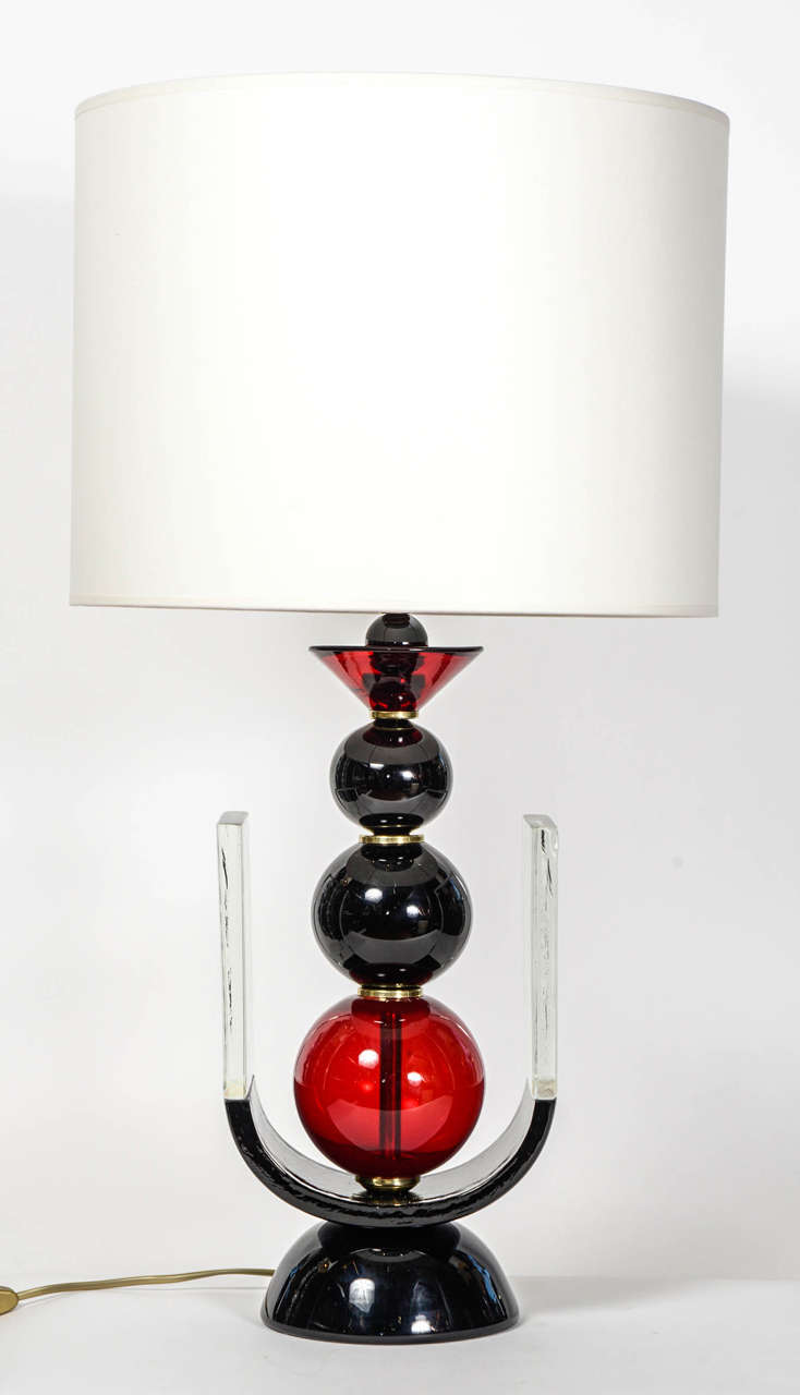 Pair of lamps entirely made of black, red and transparent Murano glass and brass setting.

New electrification.
