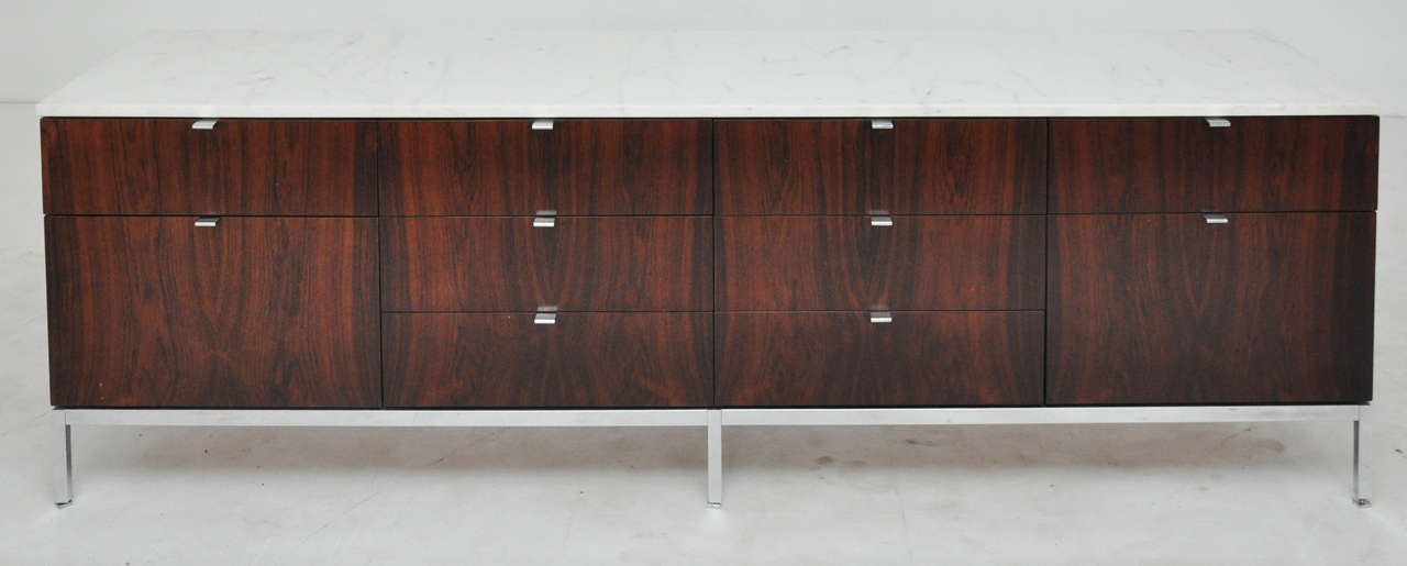 Pair of credenzas by Florence Knoll.  Rosewood cases with Carrera marble tops and steel bases.