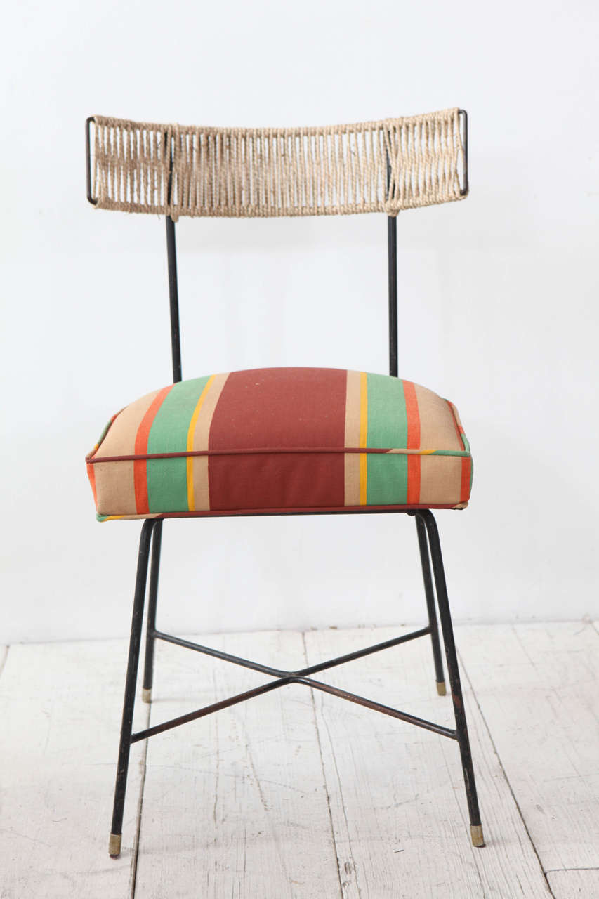 Four bistro chairs repurposed with vintage waxed African fabric and seagrass woven back.