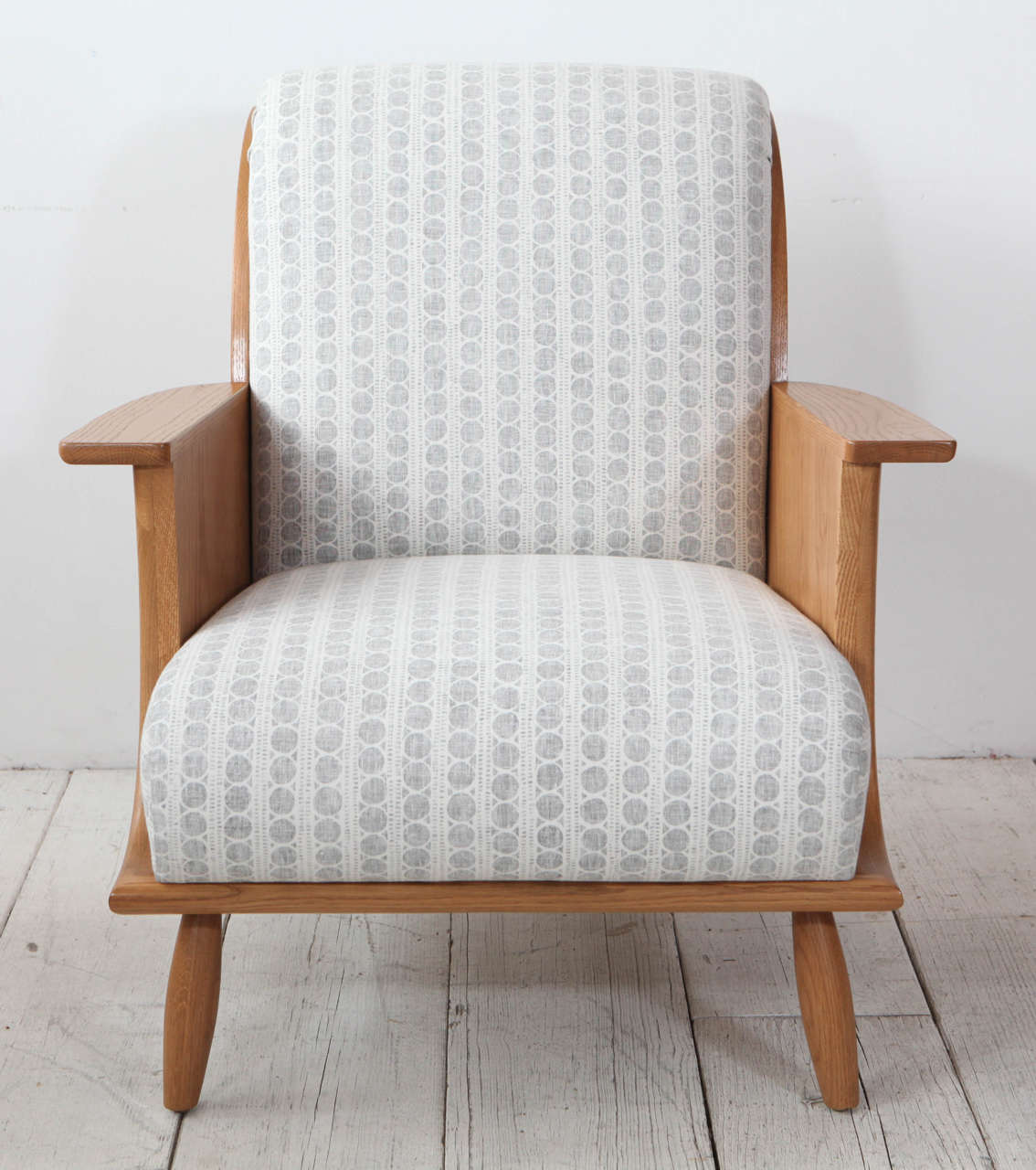 NK Collection arm chair with curved silhouette, paddle arms, and peg legs. Starting at $4,750 COM. Shown in reverse fabric from Harbinger Los Angeles.