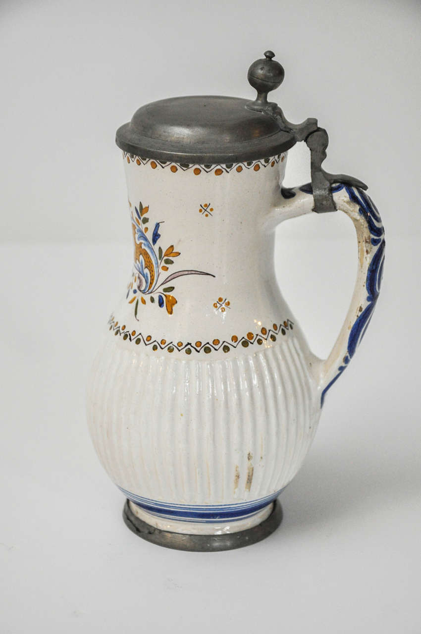 Fine Tin- Glazed Pottery on a Delicate Buff Earthenware Body,
with Pewter Mounted Lid.