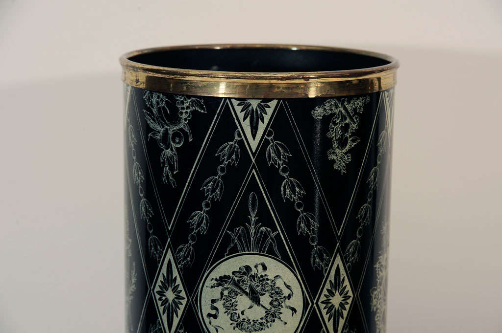 Elegant umbrella stand with <br />
lithographic transfer over wood<br />
with antique brass trim details.<br />
Stand has ancient Roman <br />
depictions in hues of black<br />
and ivory.