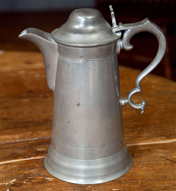 An early 19th c. lidded pewter flagon, finely detailed.