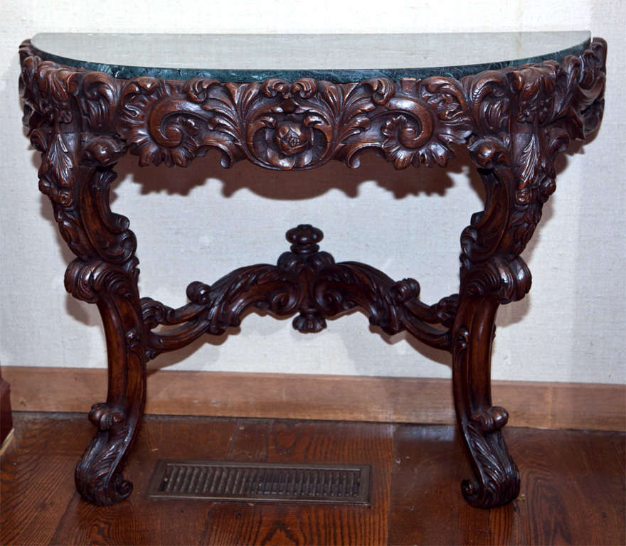 This Irish, carved oak console with marble top and open fret stretcher is proportioned beautifully for beneath a window, or mirror. The deep carving is masterfully executed in a Classic Rococo style featuring foliate accents and scrollwork.