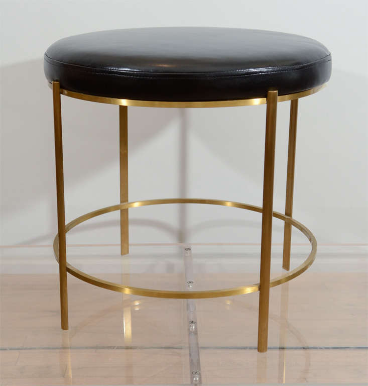 Round benches by Jacques Quinet in bronze and leather. Very fine construction with elegant proportions, the benches are both delicate and strong. Tops can be re-upholstered with client's own material.