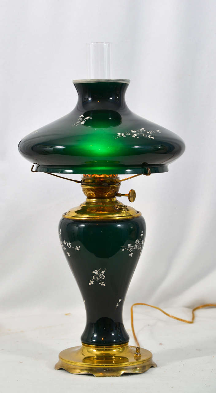 1890's Success Oil Lamp with hand painted (raised Enamel) Dogwood Design, on Green Cased Glass with a Tam-O-Shanter style Glass Shade.  It is typically know as a Doctor's Lamp.  The lamp has been totally restored  and electrified.  The metal on the