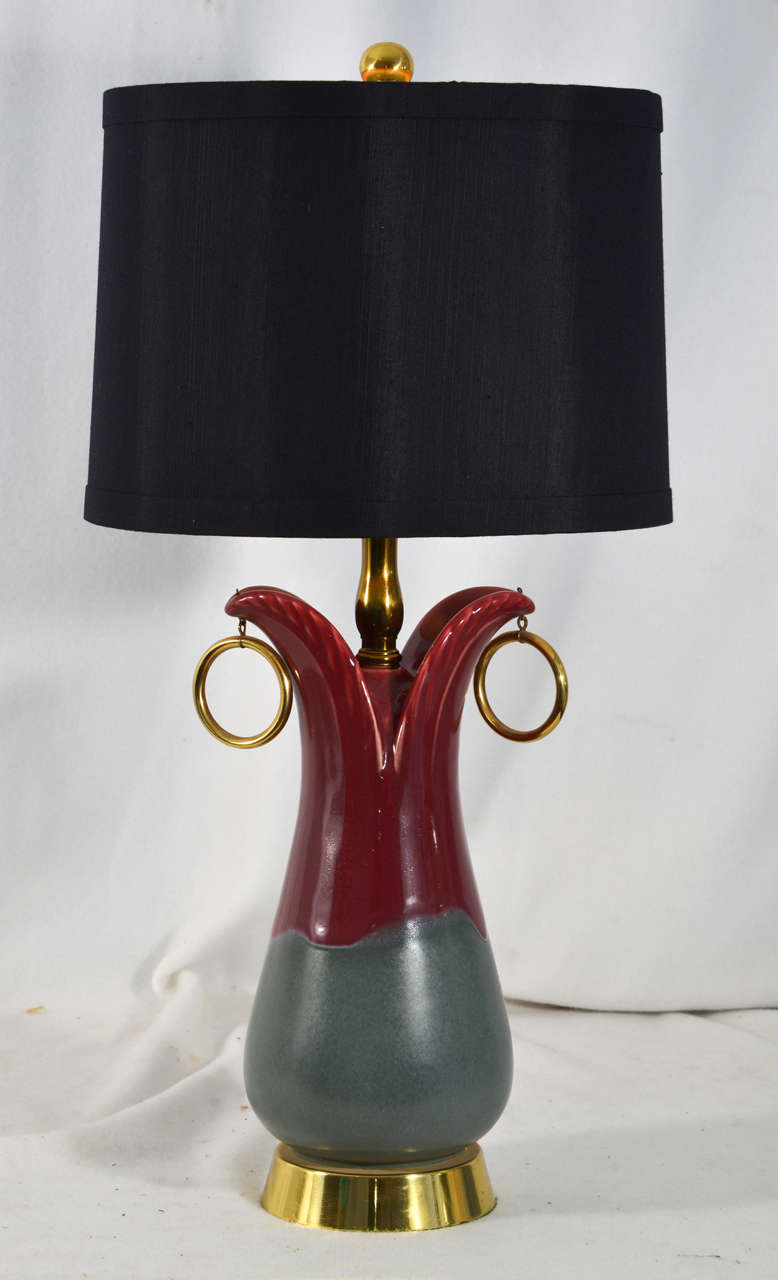Pair of 1950s Mid-Century Hollywood Regency style table lamps, accented with brass base and brass fittings. Shown with a typical drum shade in black. Reduced price to $900. For the pair. Lamps are priced priced without lamp shades. Lampshade shown