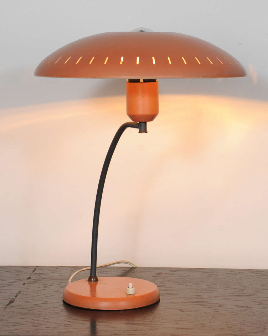 Beautiful salmon / red lacquered pair of desk light designed by the famous Dutch designer and architect Louis Kalff for the company Philips in the 1950's. The shade has a hole intended for a chrome-top lightbulb (comes with it) This light shade was