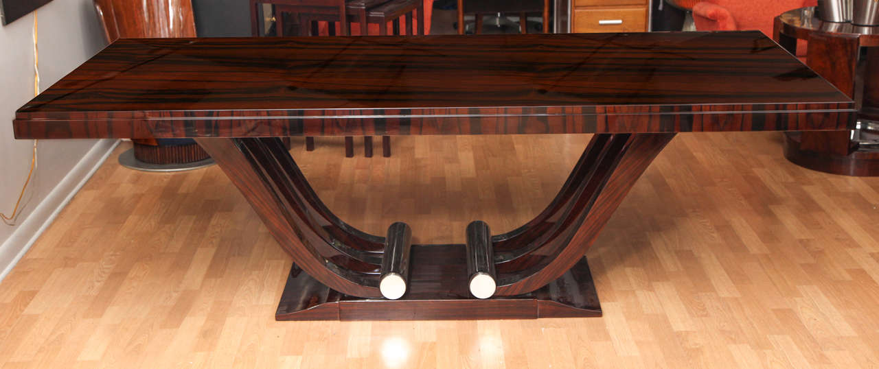 Elegant Art Deco dining table in Macassar ebony with nickel accents. It has two finished extensions of 20