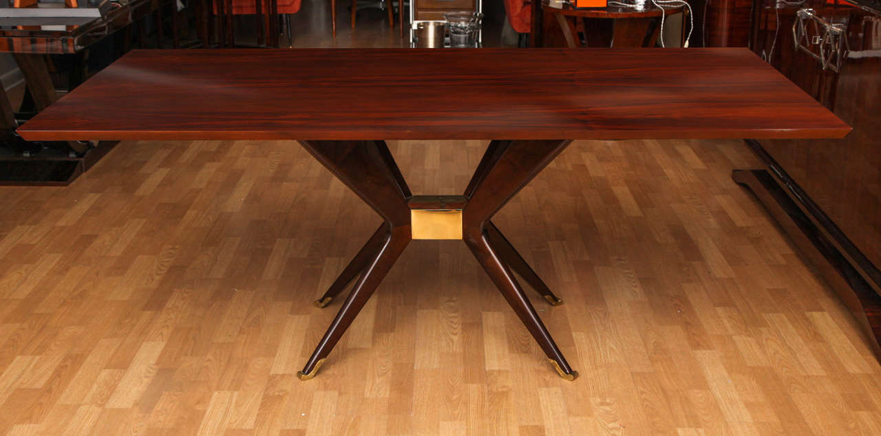 Modernist dining table in the style of Ico Parisi in walnut with bronze sabots.