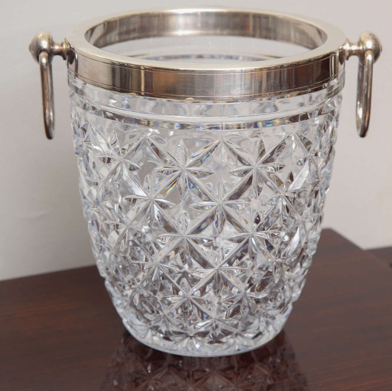 Elegant Cut crystal Champagne cooler with silver plated lip and handles.