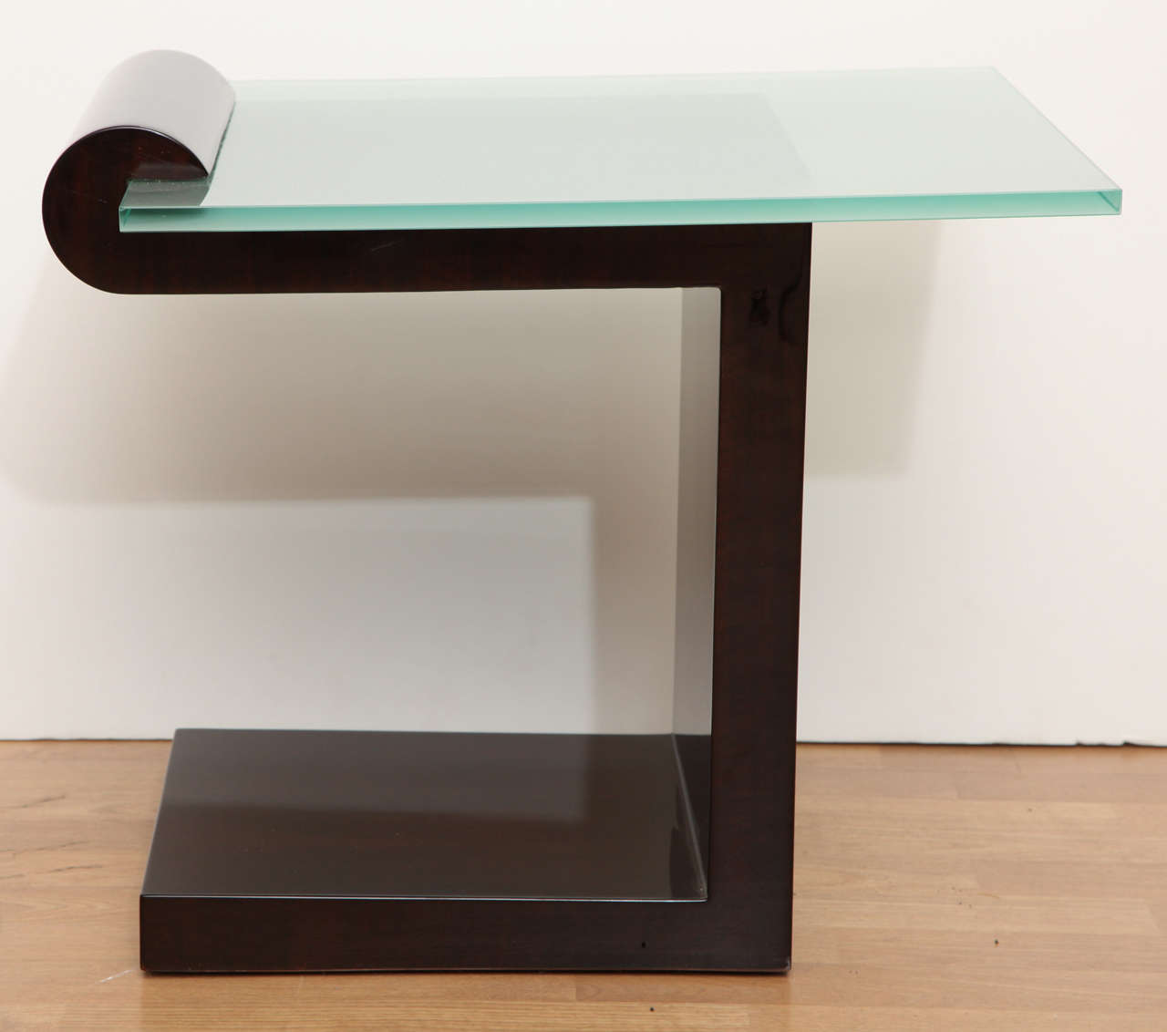 Superb Art Deco side table in dark lacquered wood with cantilevered glass top.